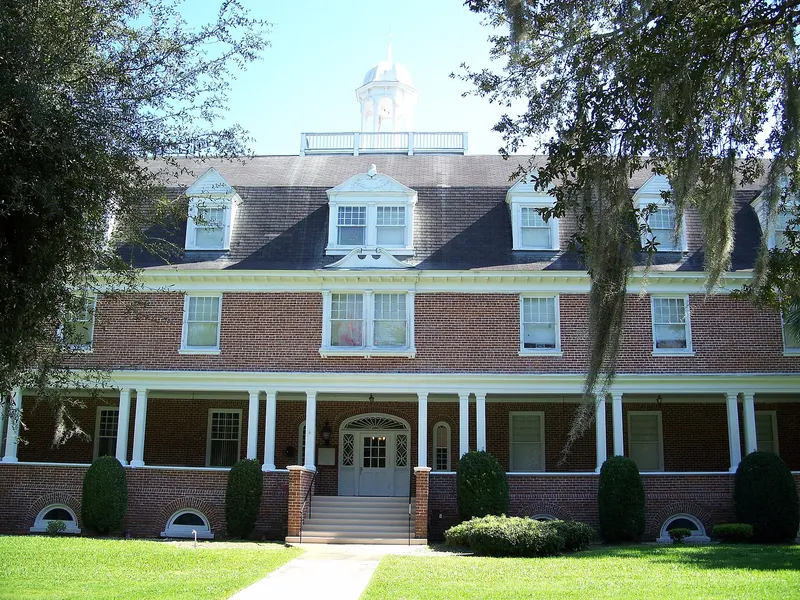 Three-storey red-brick Chaudoin Hall with a white columned porch and cupola on the Stetson University campus